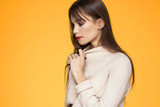 Cute brunette red lips fashionable clothes studio yellow background. High quality photo