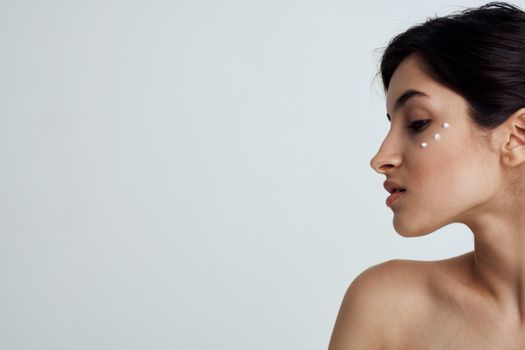 Pretty brunette naked shoulders skin care health hygiene. High quality photo