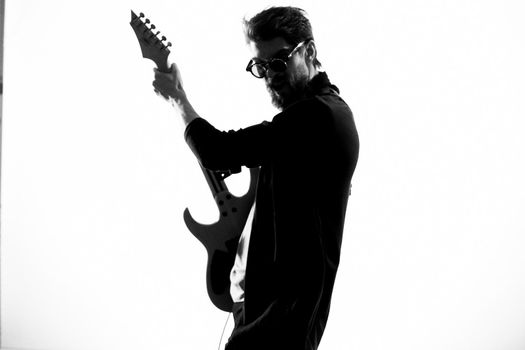 Cheerful male musician in leather jacket with sunglasses guitar performing. High quality photo
