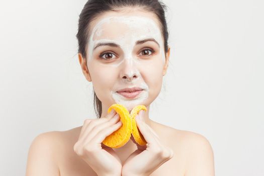 cheerful woman holding sponges in hands removing makeup scrub. High quality photo