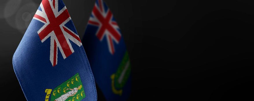 Small national flags of the British Virgin Islands on a dark background.