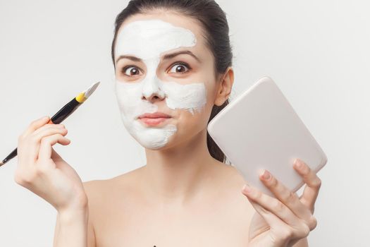 woman with bare shoulders brush in hands cosmetics skin care. High quality photo