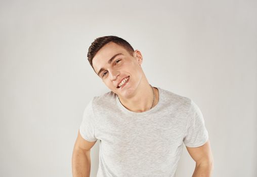 Handsome man trendy haircut white t-shirt close-up Studio. High quality photo