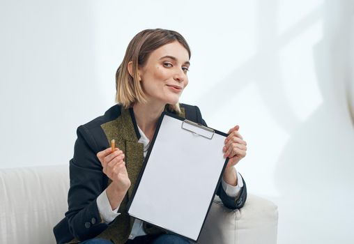 Woman manager with player documents indoors near the window. High quality photo
