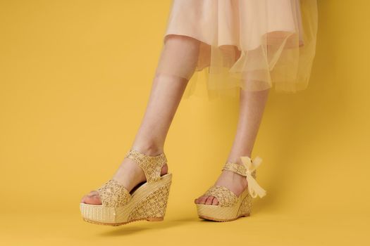 Female feet fashionable shoes attractive look yellow background lifestyle. High quality photo