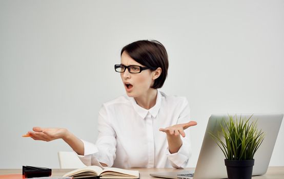 woman sitting at work table in front of laptop finance office manager. High quality photo