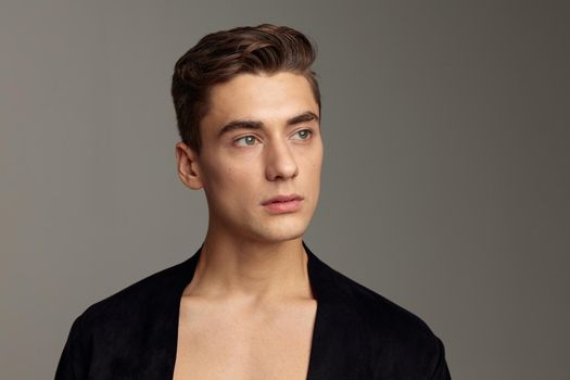 handsome man black jacket fashion hairstyle close-up attractive look model. High quality photo
