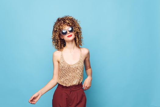 Beautiful woman Red lips curly hair fashionable clothes bright makeup cropped view
