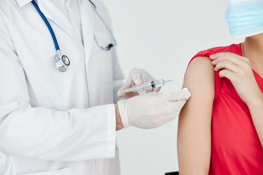 a doctor in a white coat treats the patient's hand before injection. High quality photo