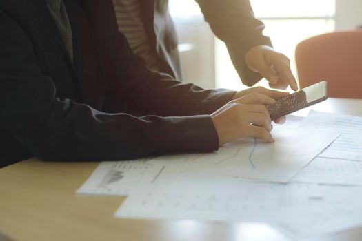 Business People hands are discussing with chart or graph documents at meeting. Teamwork, Brainstorming, Sharing, Solution, Vision, Strategy.