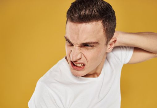 Aggressive man touches his head emotions model irritability. High quality photo