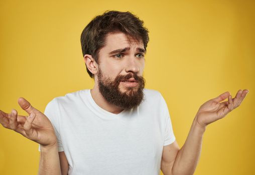 The man has his arms crossed over his chest against a yellow background cropped view. High quality photo