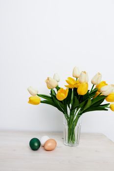 Easter holiday colorful eggs bouquet of flowers gifts. High quality photo