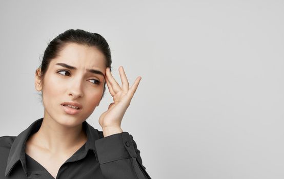 brunette in shirt holding face health problems discontent. High quality photo