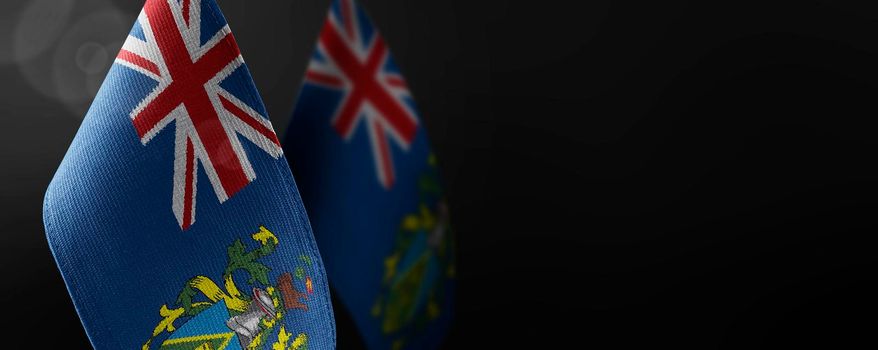 Small national flags of the Pitcairn Islands on a dark background.