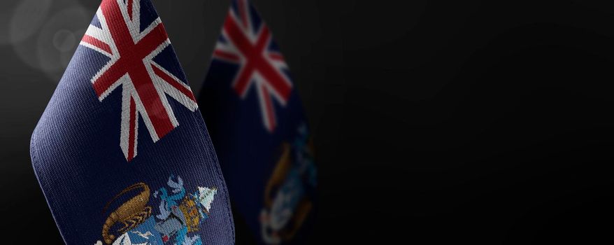 Small national flags of the Tristan da Cunha on a dark background.