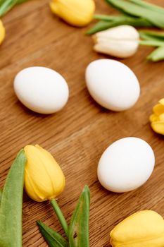 chicken eggs bouquet flowers wooden background close-up easter. High quality photo