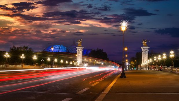 Traffic on Alexandre III bridge in Paris at sunset