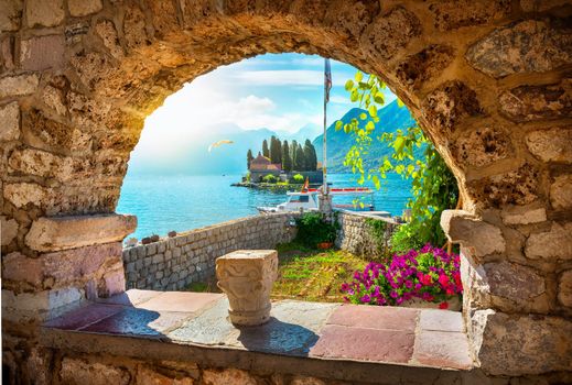 View on St George island from Our Lady of the Rocks through arch. Perast, Montenegro