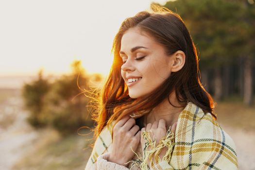happy woman with red hair at sunset near the forest. High quality photo