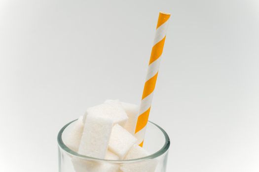 sugar cubes in a glass with a straw calories cocktail glucose sweets. High quality photo
