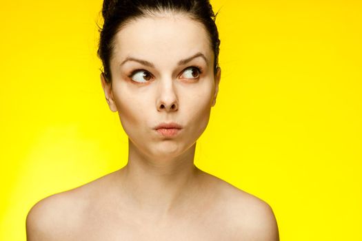 pretty woman with bare shoulders emotions fashionable yellow glasses cropped view. High quality photo