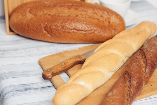 fresh loaves on a breadbasket on the table breakfast . High quality photo