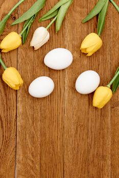 bouquet of spring flowers easter eggs decoration wooden background Copy Space. High quality photo