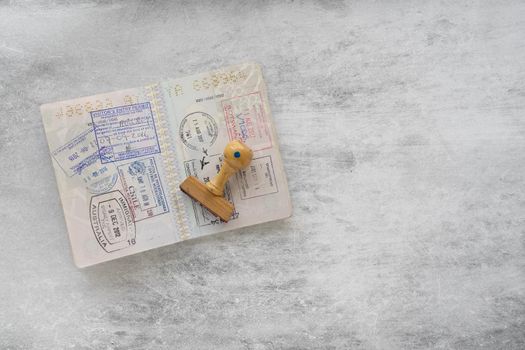 Italian passport pages with a lot of visa stamps and a rubber stamp.