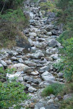 Wild river flow in forest with rock stones landscape in Taiwan.