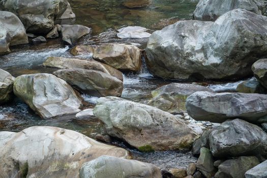 Wild river flow in forest with rock stones landscape in Taiwan.