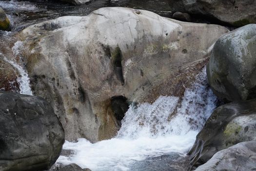 Wild river flow in forest with rock stones landscape in Taiwan.