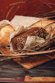 baking loaf of bread flour product in a nest on a wooden table. High quality photo
