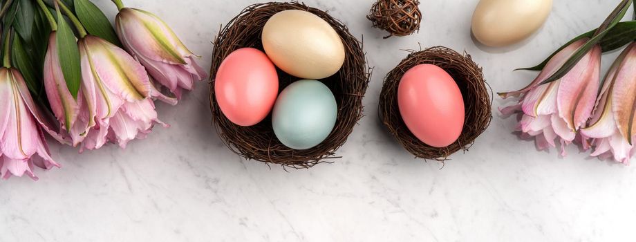 Colorful Easter eggs in the nest with pink lily flower on bright marble white table background.