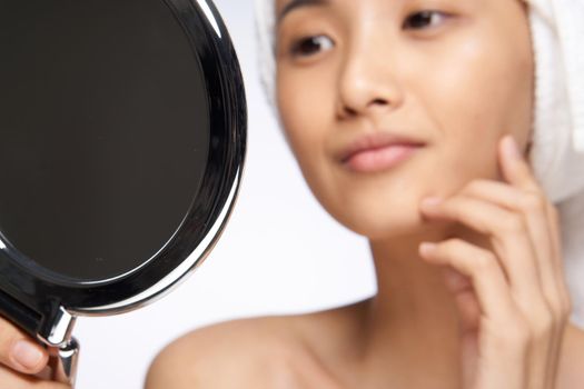 pretty woman looking in the mirror healthy skin rejuvenation spa treatments. High quality photo