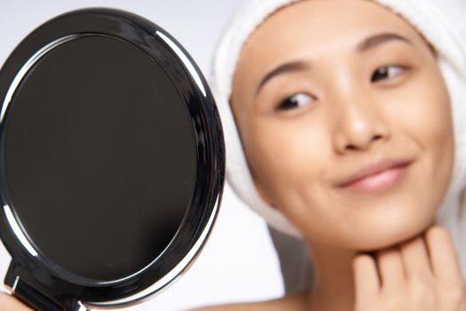 pretty woman looking in the mirror healthy skin rejuvenation spa treatments. High quality photo