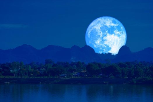 full blue worm blue moon rise back silhouette mountain blur dark cloud on the night sky, Elements of this image furnished by NASA