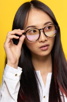 elegant woman of asian appearance with glasses close-up attractive look. High quality photo