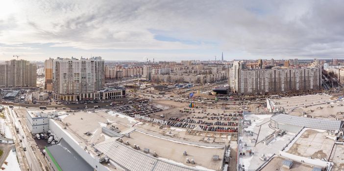 Russia, St.Petersburg, 03 March 2021: The Aerial view of the huge crossroad at metro station Pioneerskaya, Ispytateley Avenue and Kolomyazhsky, huge houses, developing shopping center. High quality image