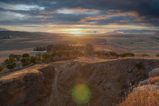 Small Andalusian town in southern Spain photographed from the top of a mountain with clouds