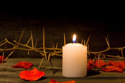 thorns candle and rose petals christian symbol