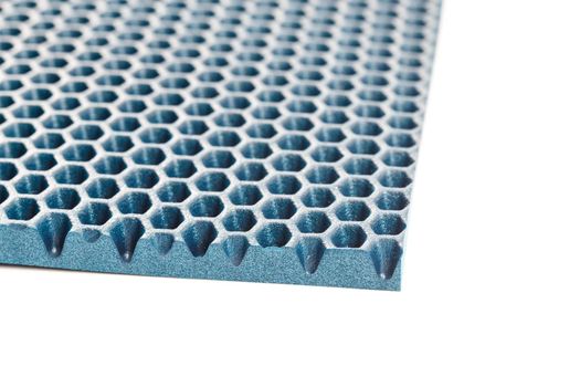 blue hexagonal punched EVA - ethylene vinyl acetate foam carpet linear perspective background with selective focus.