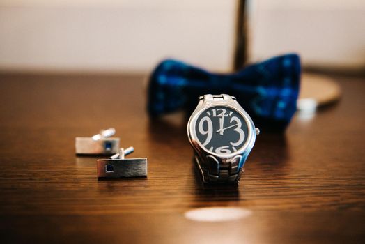 wedding ring in a box and watch the groom on the table