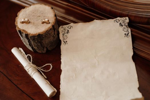 wedding invitation in a gray envelope on a table with green sprigs