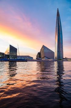 Russia, St.Petersburg, 03 July 2020: The color image of skyscraper Lakhta center at sunset, Reflection of the sunset sky in a glass facade of the building, It is the highest skyscraper in Europe, Completion of construction