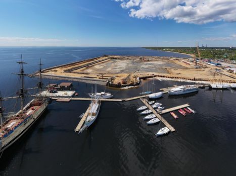 Russia, St.Petersburg, 26 May 2020: Aerial view of the new port under construction near the highest skyscraper in Europe Lakhta center by oil company Gazprom, sunny weather