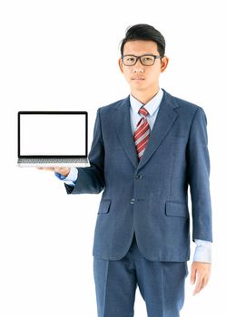 Young asian businessman portrait in suit and wear glasses holding a laptop over white background