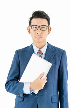 Young asian businessman portrait in suit and wear glasses holding a laptop over white background