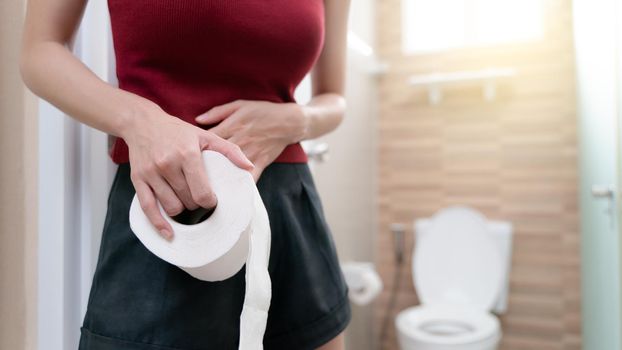 woman with toilet paper, stomachache diarrhea symptom, menstrual period cramp or food poisoning. Health care concept.