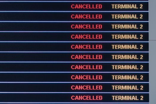 Flights cancellation status on flights information board in airport because coronavirus or pandemic effected.